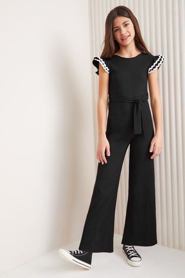 Buy Lipsy Black White Jersey Rib Ruffle Jumpsuit 5 16yrs from