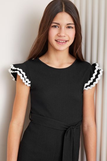 Black jumper dress with white frill discount