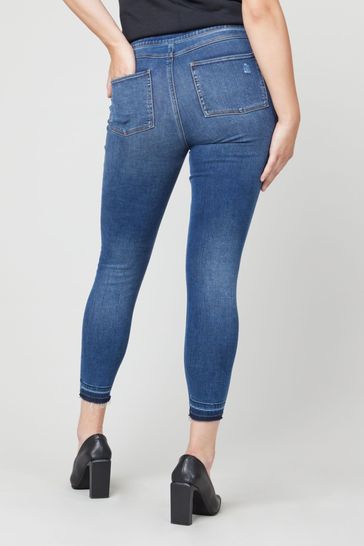 Buy SPANX® Medium Control Distressed Denim Skinny Jeans from Next Estonia