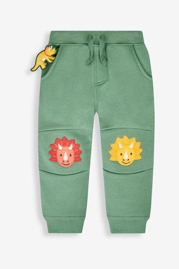 Pantalones de chándal verde caqui con aplique de dinosaurio en las rodillas y mascota en el bolsillo de Jojo Maman Bébé