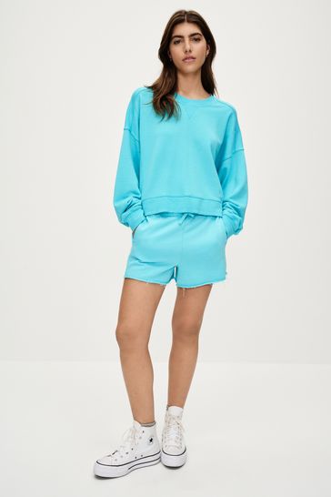 Buy Fluro Blue Raw Hem Detail Washed Crew Neck Sweatshirt from Next Netherlands