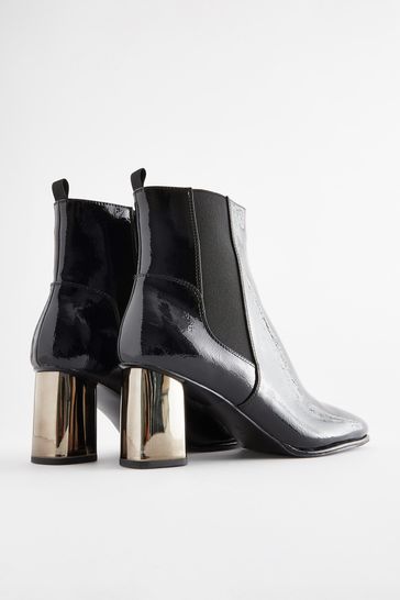Black boots shop with metallic heel