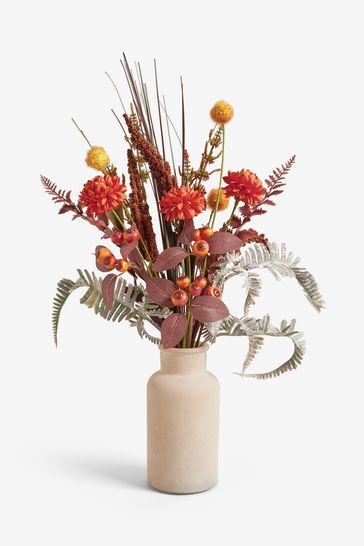 Orange artificial shop flowers in vase