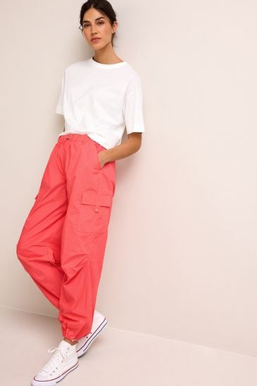 Bright pink cargo trousers on sale