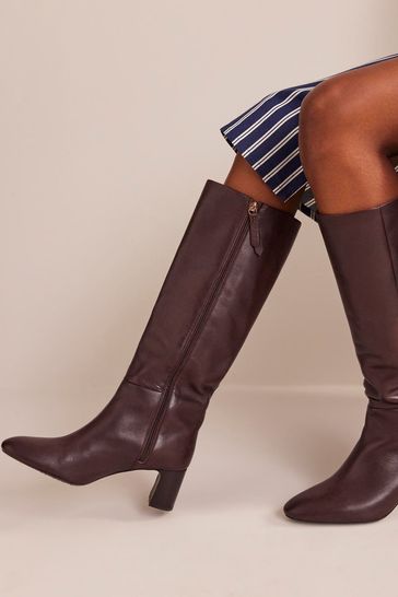 Black and brown knee high deals boots