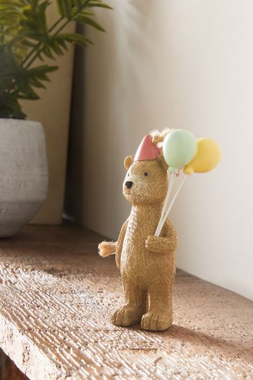 Teddy bear hanging from balloons 2025