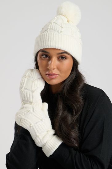 Cream hat with fur pom pom deals