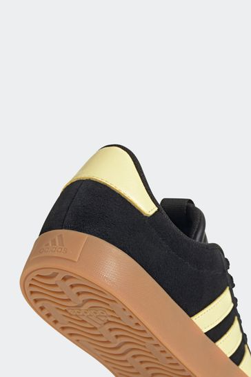 Black and yellow adidas trainers 2025