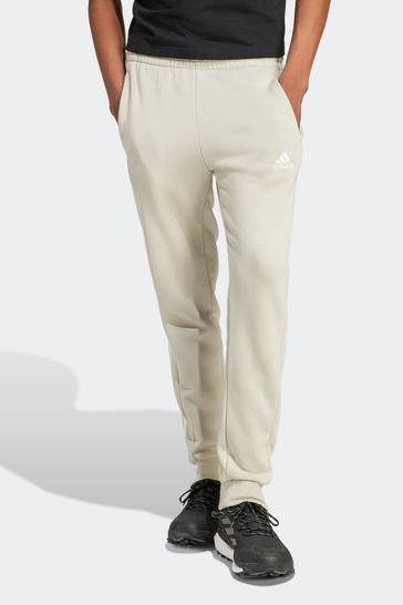 Pantalones de chándal de tejido polar y corte cónico con bajos elásticos y 3bandas en marrón Essentials de adidas Sportswear