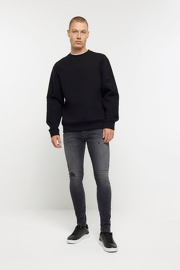 Black spray best sale on skinny jeans