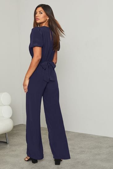 Buy Lipsy Navy Regular Puff Sleeve Tie Waist Jumpsuit from Next