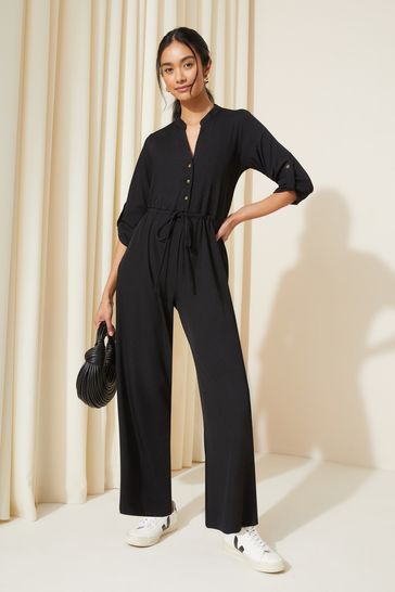 Friends Like These Black Petite Jersey Long Sleeve Cinched Waist Jumpsuit