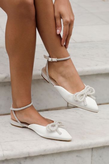 Buy Linzi Cream Lalita Flat Mules With Pearl Embellished Front Bow from Next Bahrain