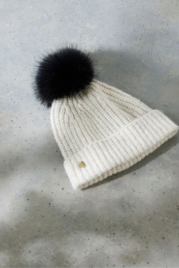 Black hat with cream bobble hot sale