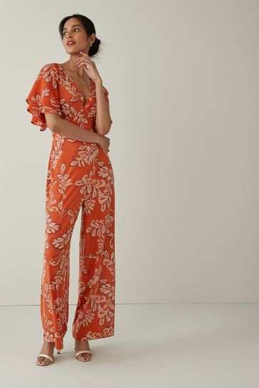 Buy Orange Leaf Print Flute Sleeve V Neck Jumpsuit from Next Slovakia