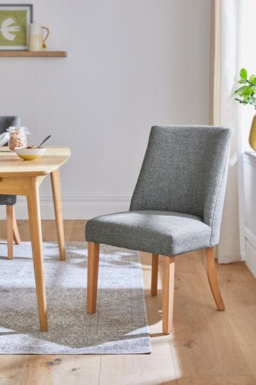 Grey fabric dining chairs with oak legs top