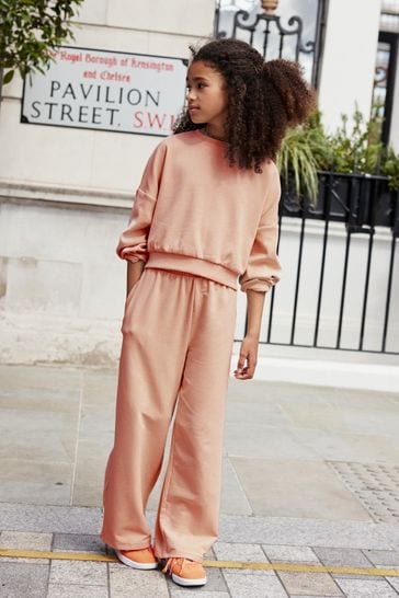 Women's Two Piece Cropped Jogging Suit - Long Sleeves / Cuffed Pants / Pink