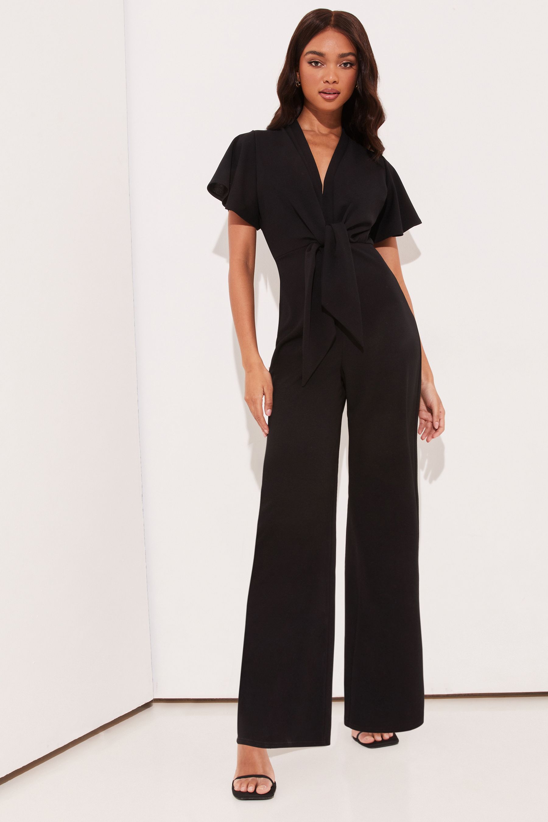 Buy Lipsy Flutter Sleeve V Neck Tie Front Wide Leg Jumpsuit from Next ...