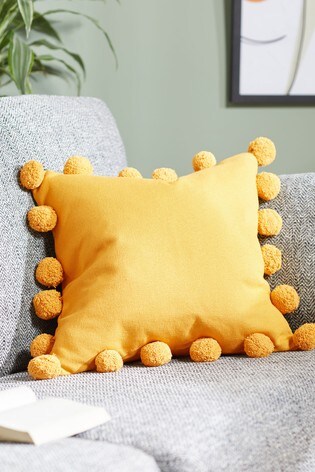 Yellow pom pom pillow