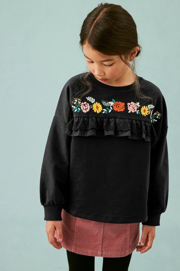 Black jumper with top embroidered flowers