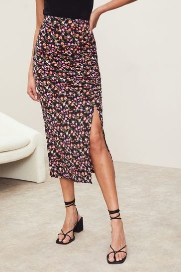 Buy Lipsy Black Ditsy Petite Petite Ruched Front Jersey Midi Skirt
