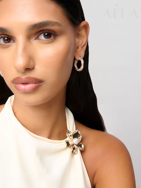 Aela Gold Tone Sparkle Twist Hoop Earrings (W84713) | 65 QAR