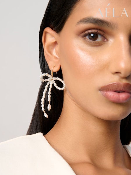 Aela Cream Pearl Bow Drop Earrings (W96435) | 75 ر.ق.