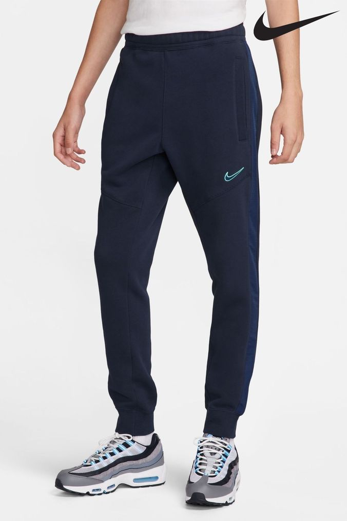Nike colour block joggers in blue and green 2025 neutrals
