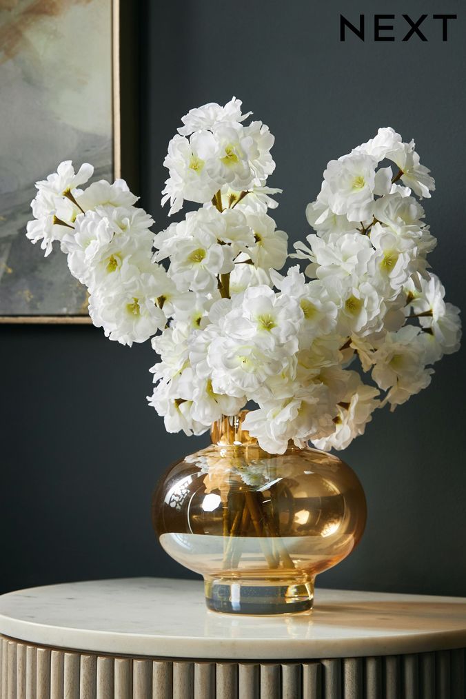 White artificial store flowers in vase