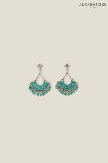 Blue earrings accessorize top