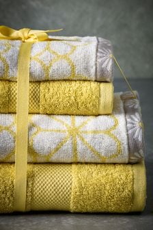 Stapel gele must-have handdoeken met madeliefjespatroon