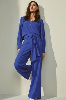 Kobaltowy niebieski - Dopasowane spodnie z krepy z rozkloszowaną nogawką (A44731) | 94 zł