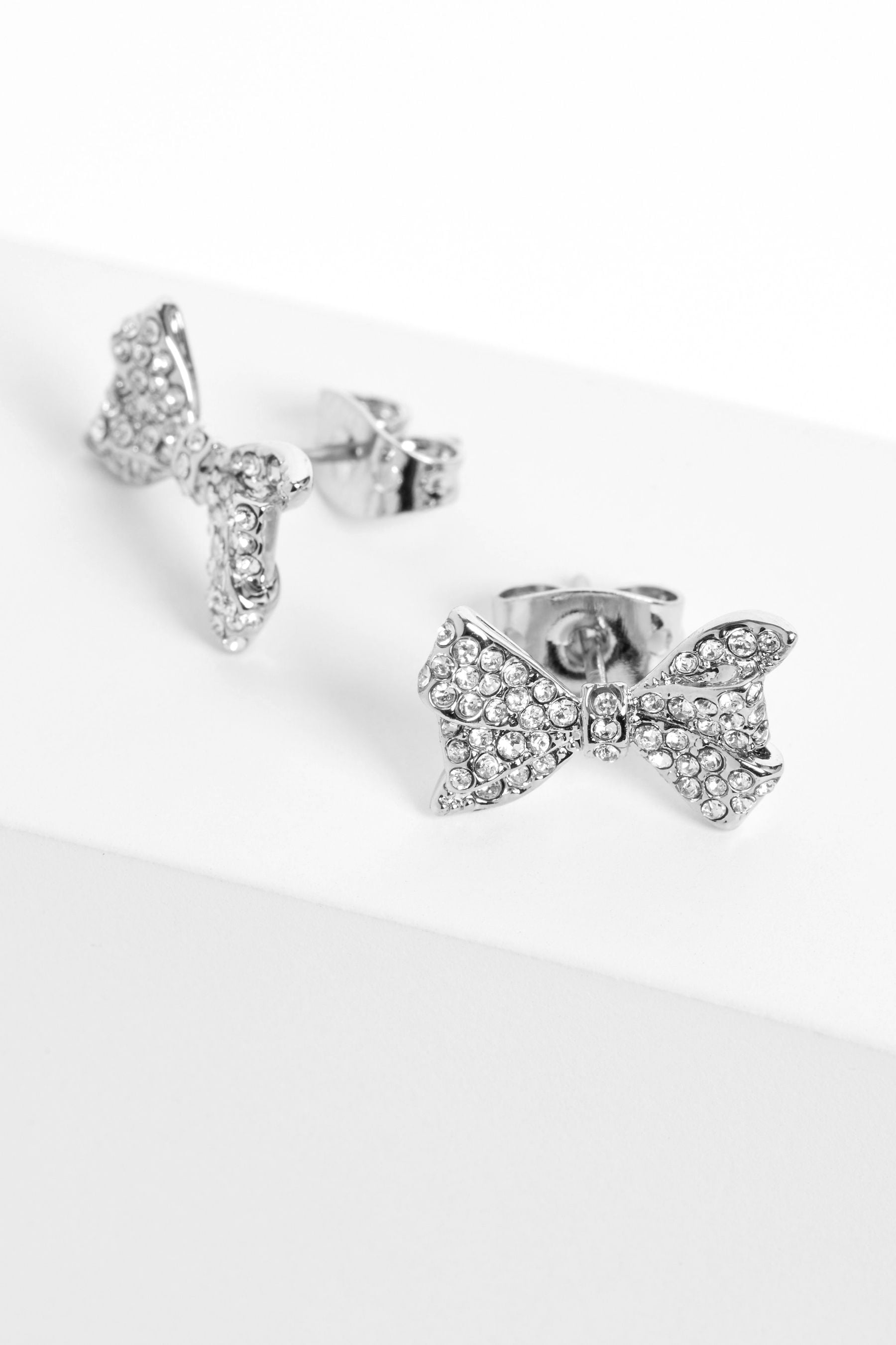 Buy Ted Baker Silver Tone BARSETA Crystal Bow Stud Earrings from the ...