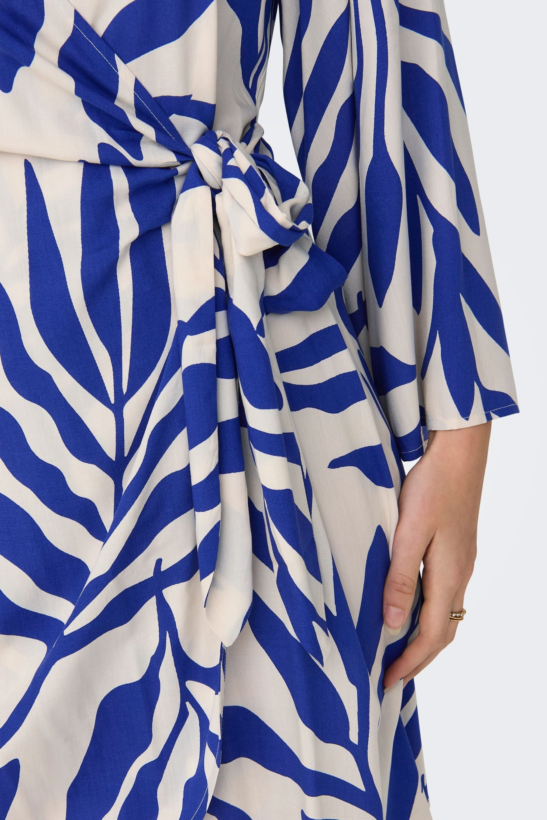 Buy JDY Blue Leaf Print Wrap Mini Dress from the Next UK online shop image.