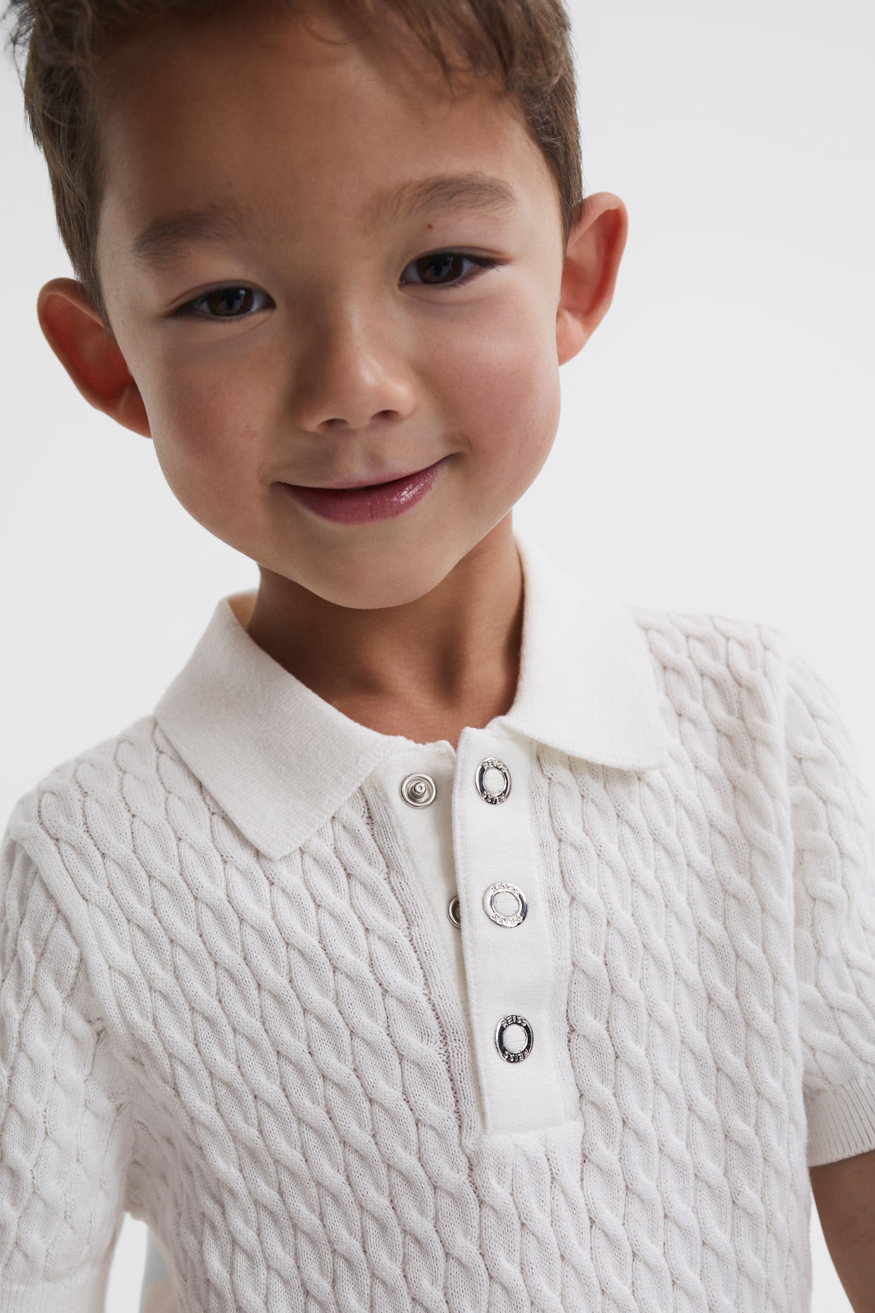 Buy Reiss Ecru Eli Junior Press Stud Cable Knit Polo Shirt from the