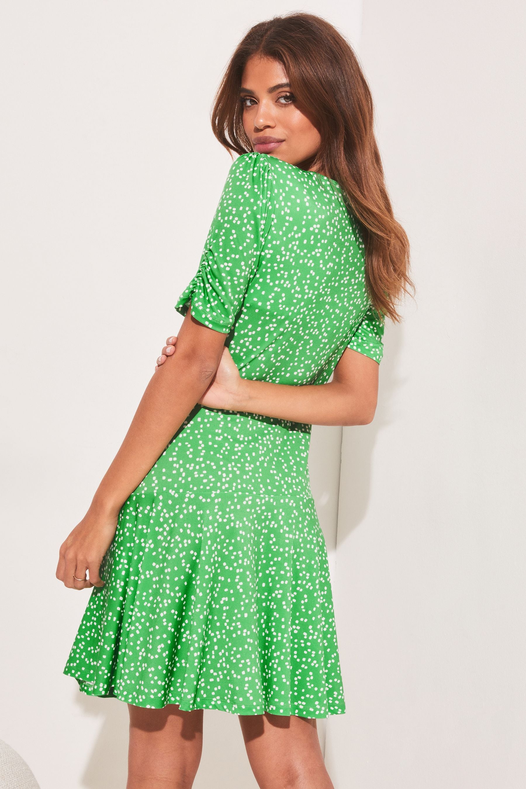 Buy Lipsy Green Spot Petite Jersey Knot Front Mini Skater Dress from