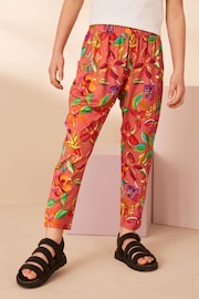 Rust Orange/ Pink Tropical Flower Print Jersey Stretch Lightweight Trousers (3-16yrs) - Image 1 of 8