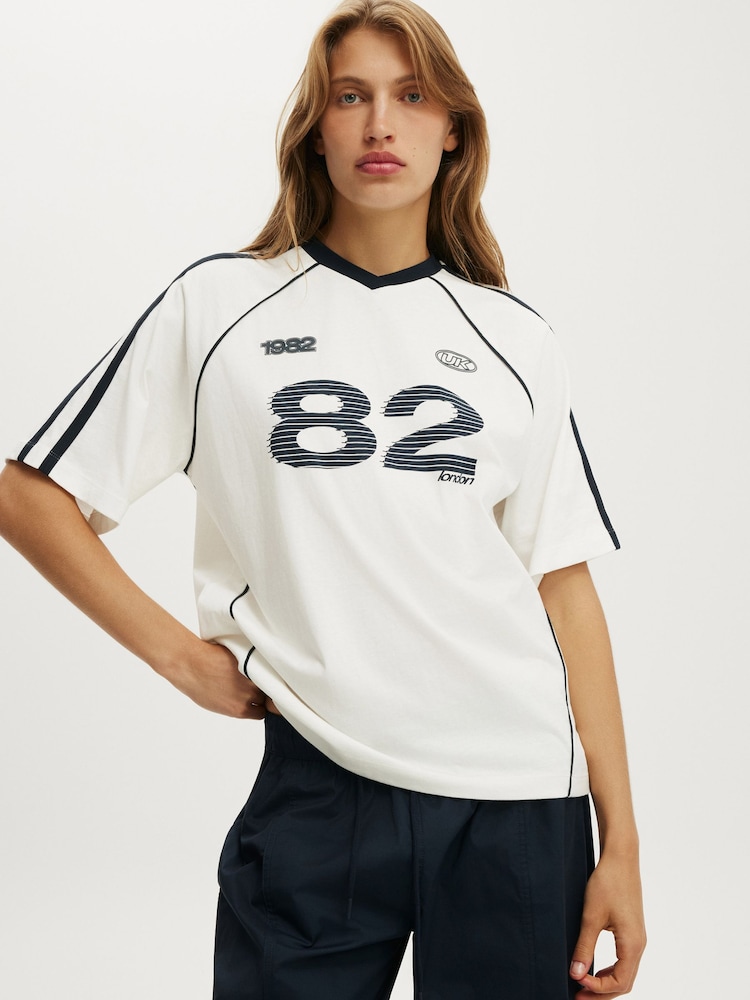 Cotton On White V-Neck Oversized Raglan Graphic T-Shirt - Image 1 of 2 Cotton On White V-Neck Oversized Raglan Graphic T-Shirt - Image 1 of 2