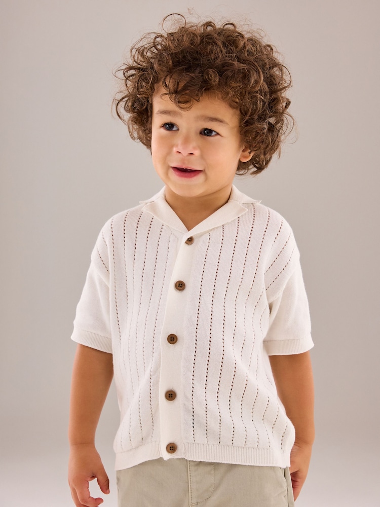 White 100% Cotton Short Sleeved Button Through Polo Shirt (3mths-7yrs) - Image 1 of 11 White 100% Cotton Short Sleeved Button Through Polo Shirt (3mths-7yrs) - Image 1 of 11