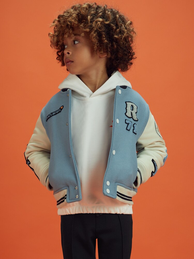 Reiss x McLaren F1 Team Airforce Blue/Ecru 3-9 yrs McLaren F1 Leather Varsity Jacket - Image 1 of 9 Reiss x McLaren F1 Team Airforce Blue/Ecru 3-9 yrs McLaren F1 Leather Varsity Jacket - Image 1 of 9