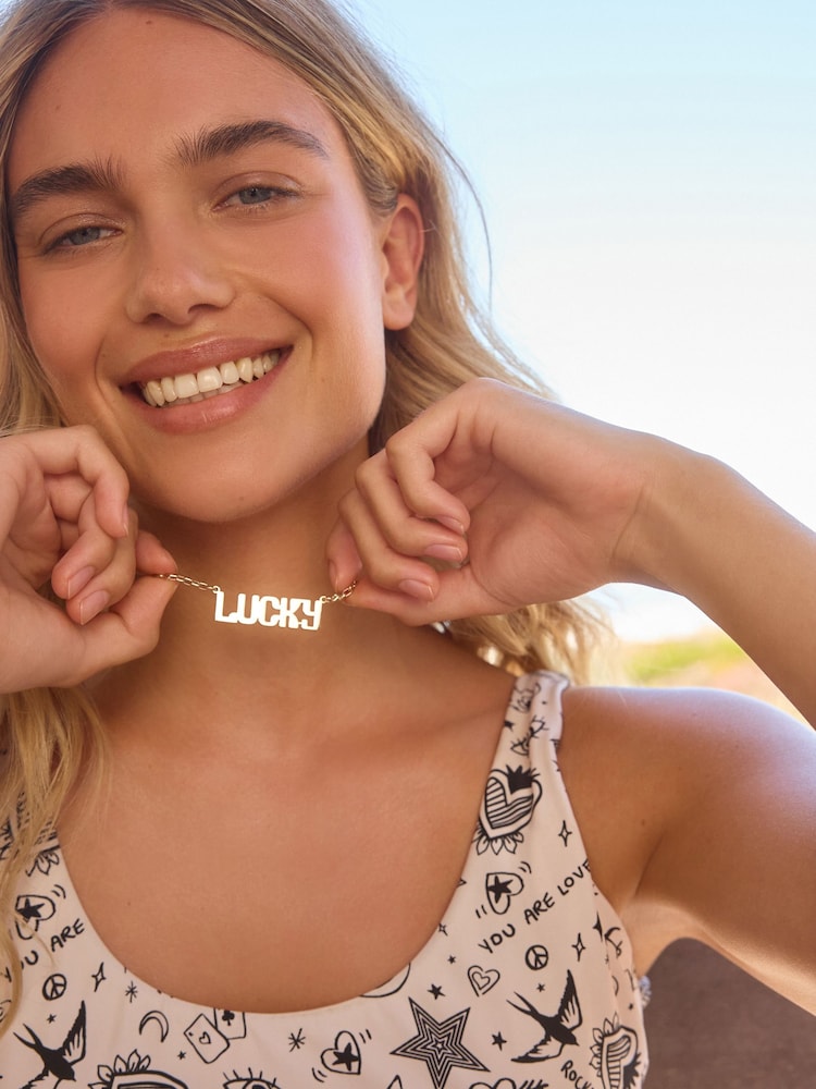 Rockett St George Gold Tone Lucky Slogan Necklace - Image 1 of 4 Rockett St George Gold Tone Lucky Slogan Necklace - Image 1 of 4