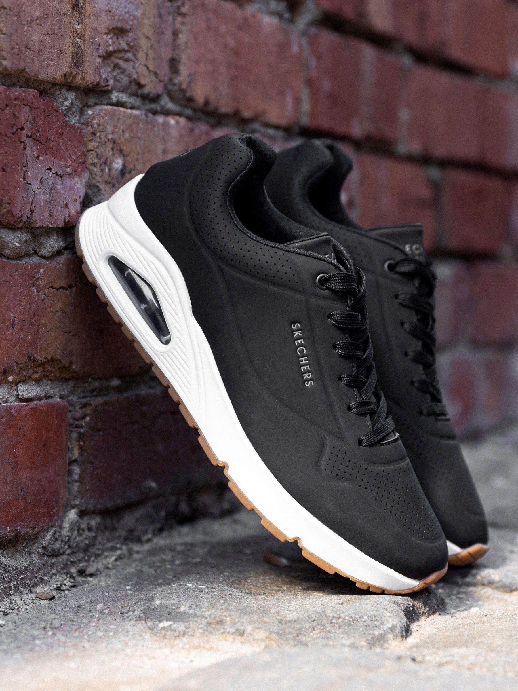 Buy Skechers Black White Standard Fit Mens Uno Stand On Air Lace Up Sports Trainers from Next Oman