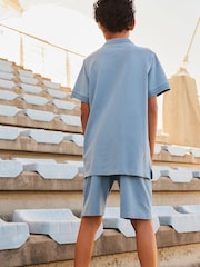 Blau - Polo-Shirt mit Reißverschluss am Kragen aus 100 % Baumwolle und Shorts im Set (3–16 Jahre) - Bild 3 von 7