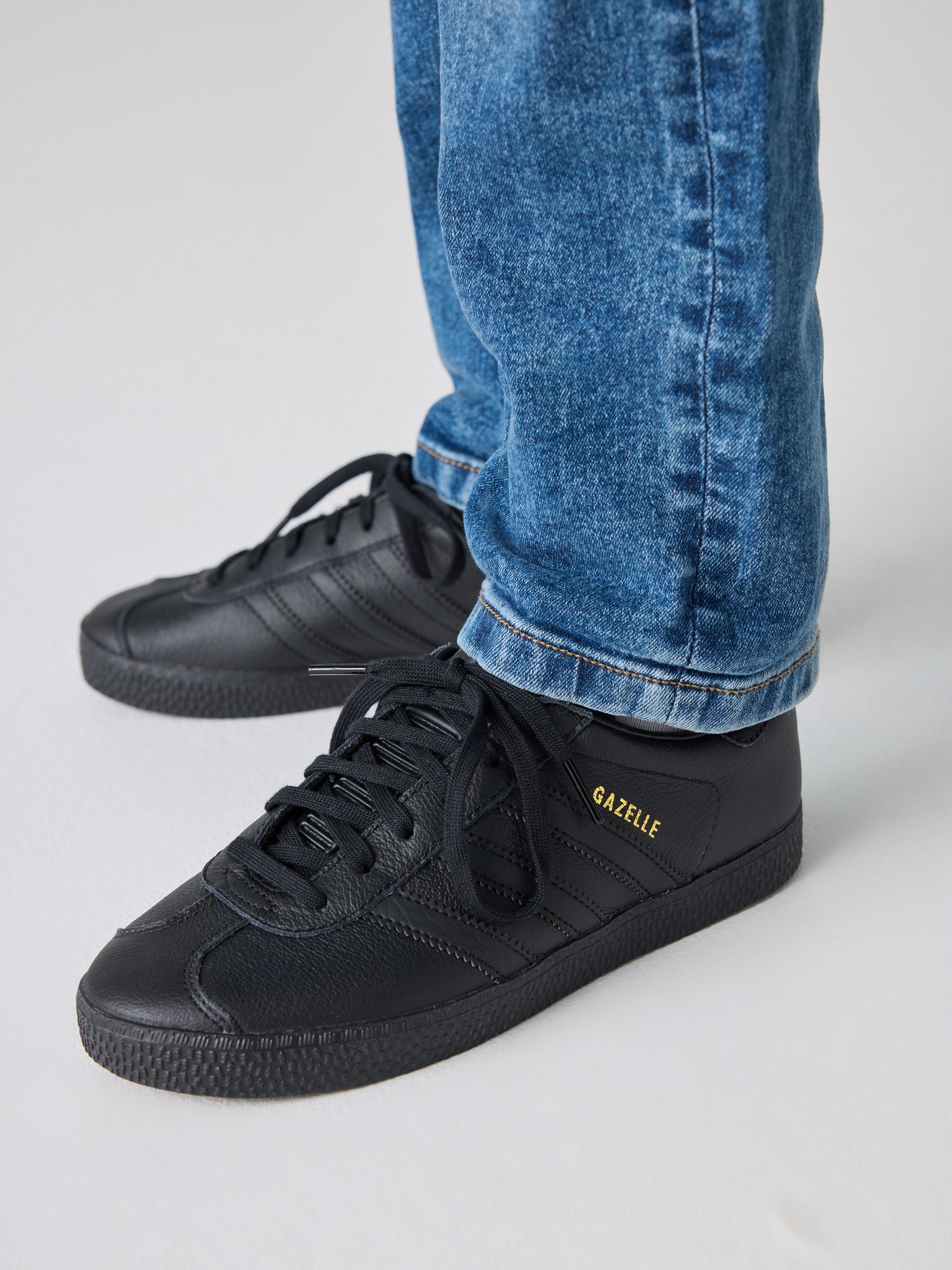 Black leather adidas gazelle junior hotsell