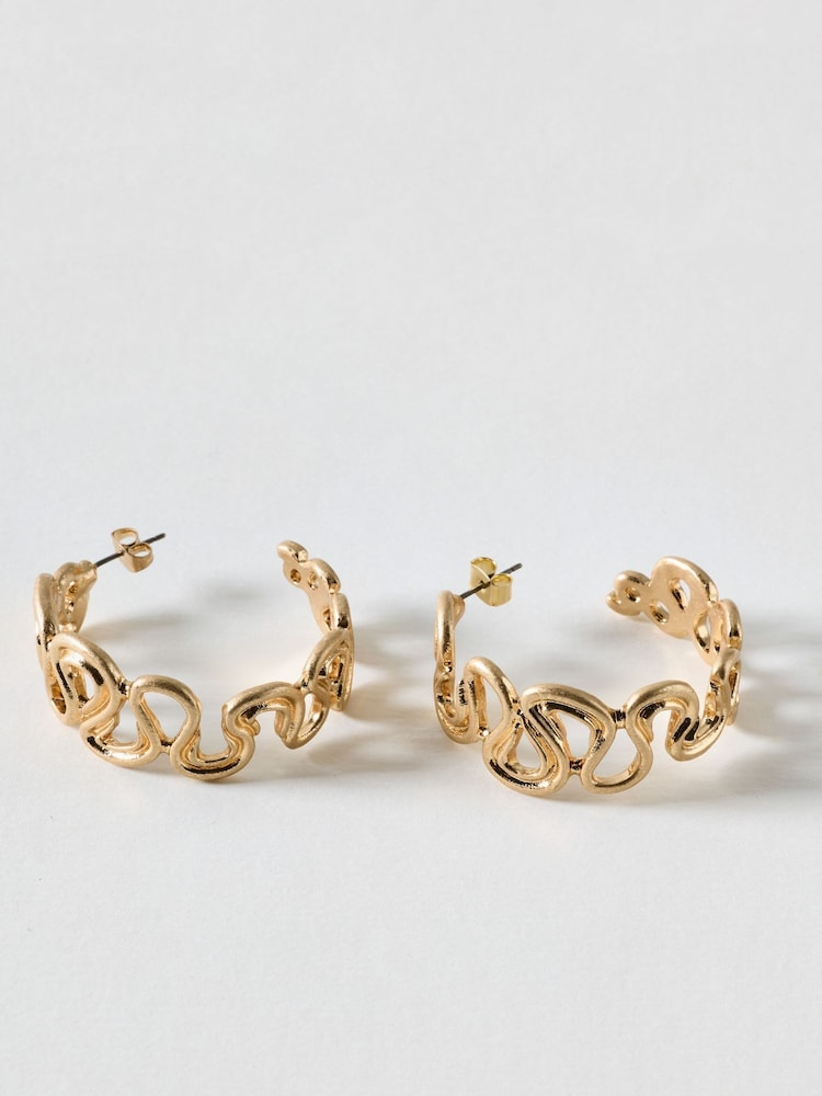 Oliver Bonas Gold Gladys Wavy Brushed Metal Hoop Earrings - Image 1 of 4 Oliver Bonas Gold Gladys Wavy Brushed Metal Hoop Earrings - Image 1 of 4