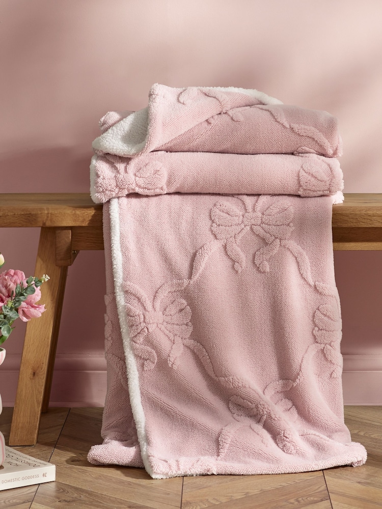Catherine Lansfield Pink Carved Bow Cosy Fleece Blanket Throw - Image 1 of 3 Catherine Lansfield Pink Carved Bow Cosy Fleece Blanket Throw - Image 1 of 3
