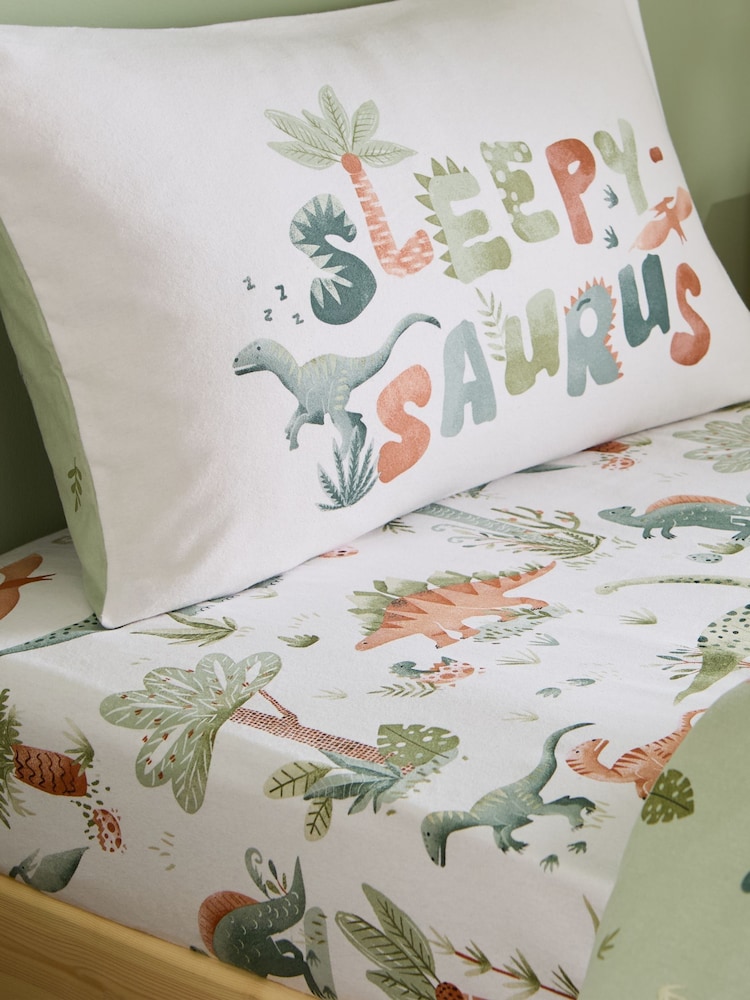 Catherine Lansfield Cream Sleepy Saurus Dino Brushed Cotton Fitted Sheet - Image 1 of 2 Catherine Lansfield Cream Sleepy Saurus Dino Brushed Cotton Fitted Sheet - Image 1 of 2