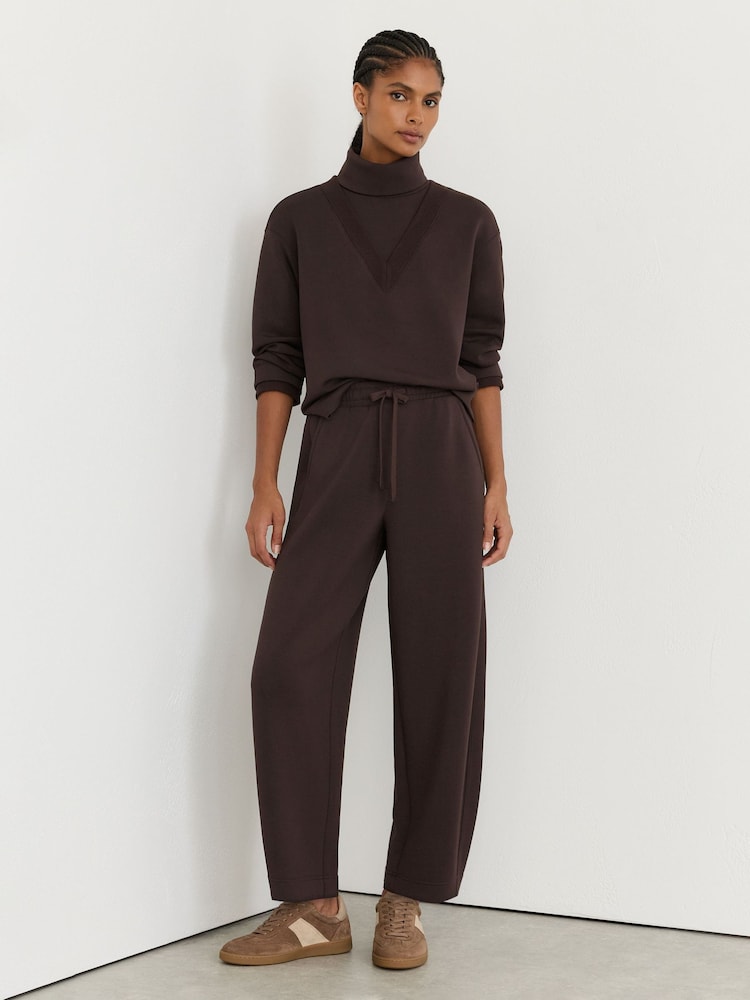Reiss Dark Chocolate Brown Abigail Petite Premium Interlock Barrel-Leg Joggers - Image 1 of 7 Reiss Dark Chocolate Brown Abigail Petite Premium Interlock Barrel-Leg Joggers - Image 1 of 7