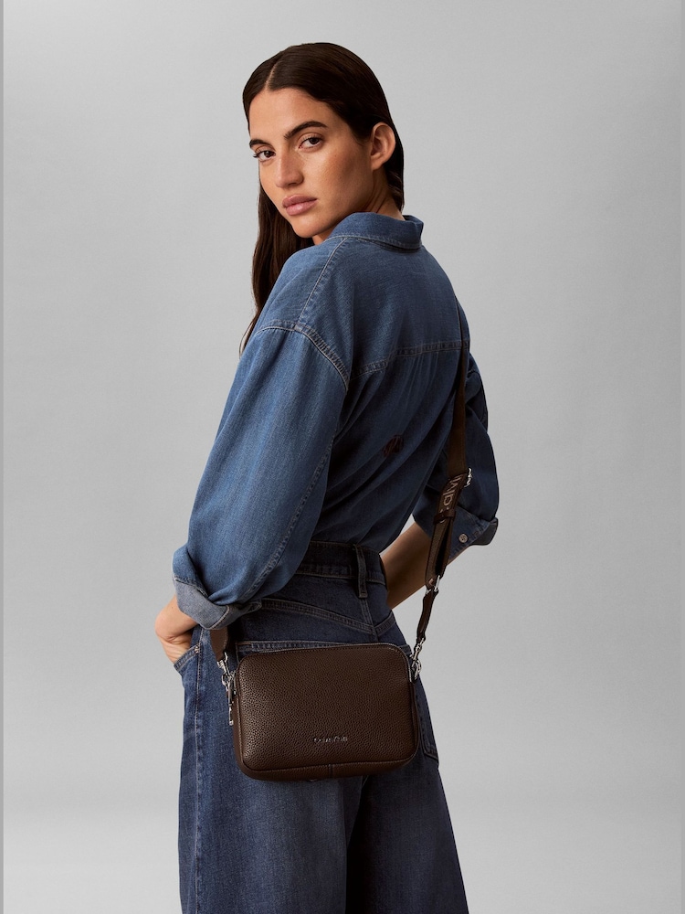 Calvin Klein Brown Logo Strap Camera Bag - Image 1 of 4 Calvin Klein Brown Logo Strap Camera Bag - Image 1 of 4