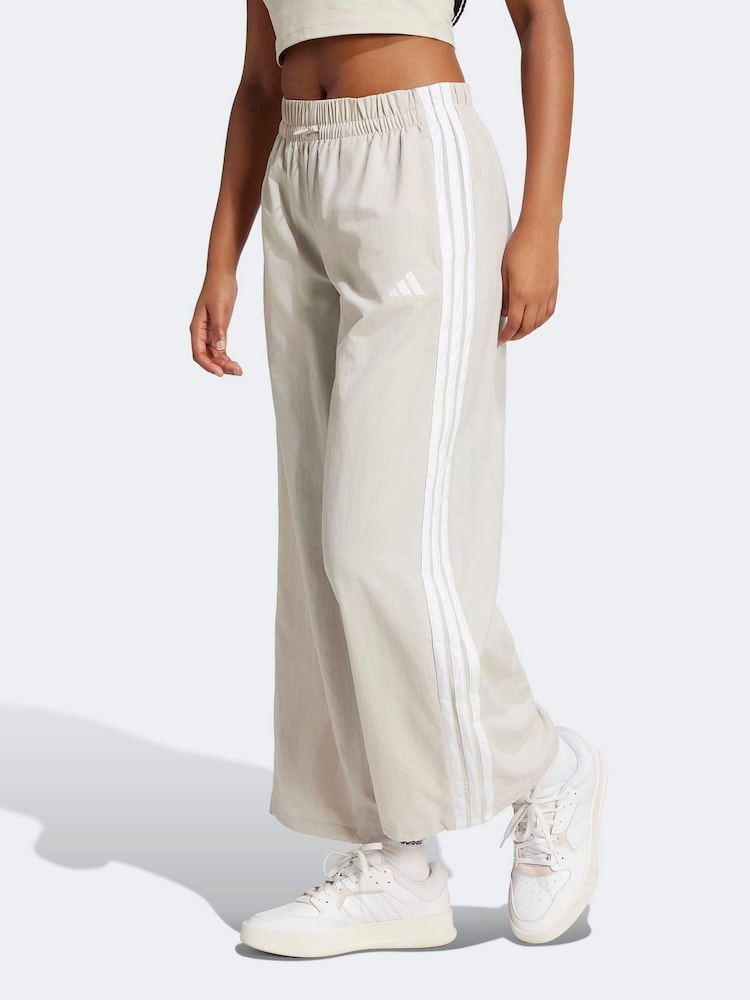 adidas Cream Essentials 3-Stripes Lifestyle Woven Parachute Tracksuit Bottoms - Image 1 of 6 adidas Cream Essentials 3-Stripes Lifestyle Woven Parachute Tracksuit Bottoms - Image 1 of 6